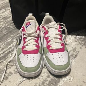 Nike girls’ sneakers. Low tops, white with pink, olive, navy, and black trim.